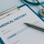 Medical history form on a clipboard with a pen and stethoscope