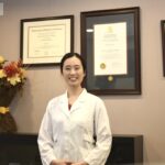 Dr. Cindy Li, DDS at Excel Dental in Hamilton, ON: Dr. Cindy Li smiling in her dental office at Excel Dental in Hamilton, Ontario.