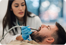 Dentist providing an oral surgery procedure